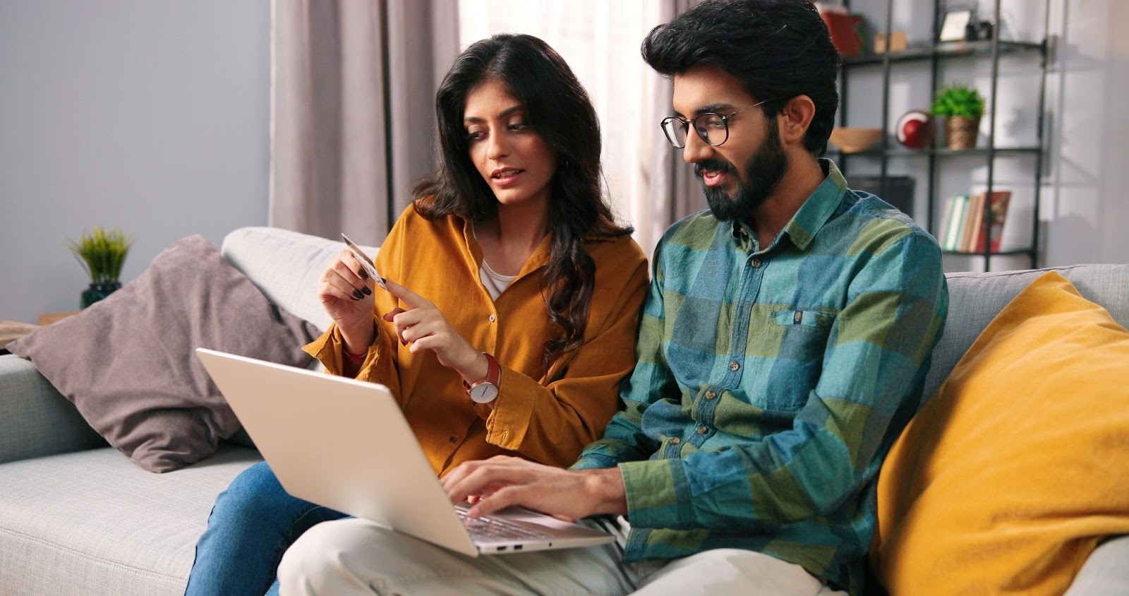 Couple working together on a laptop at home