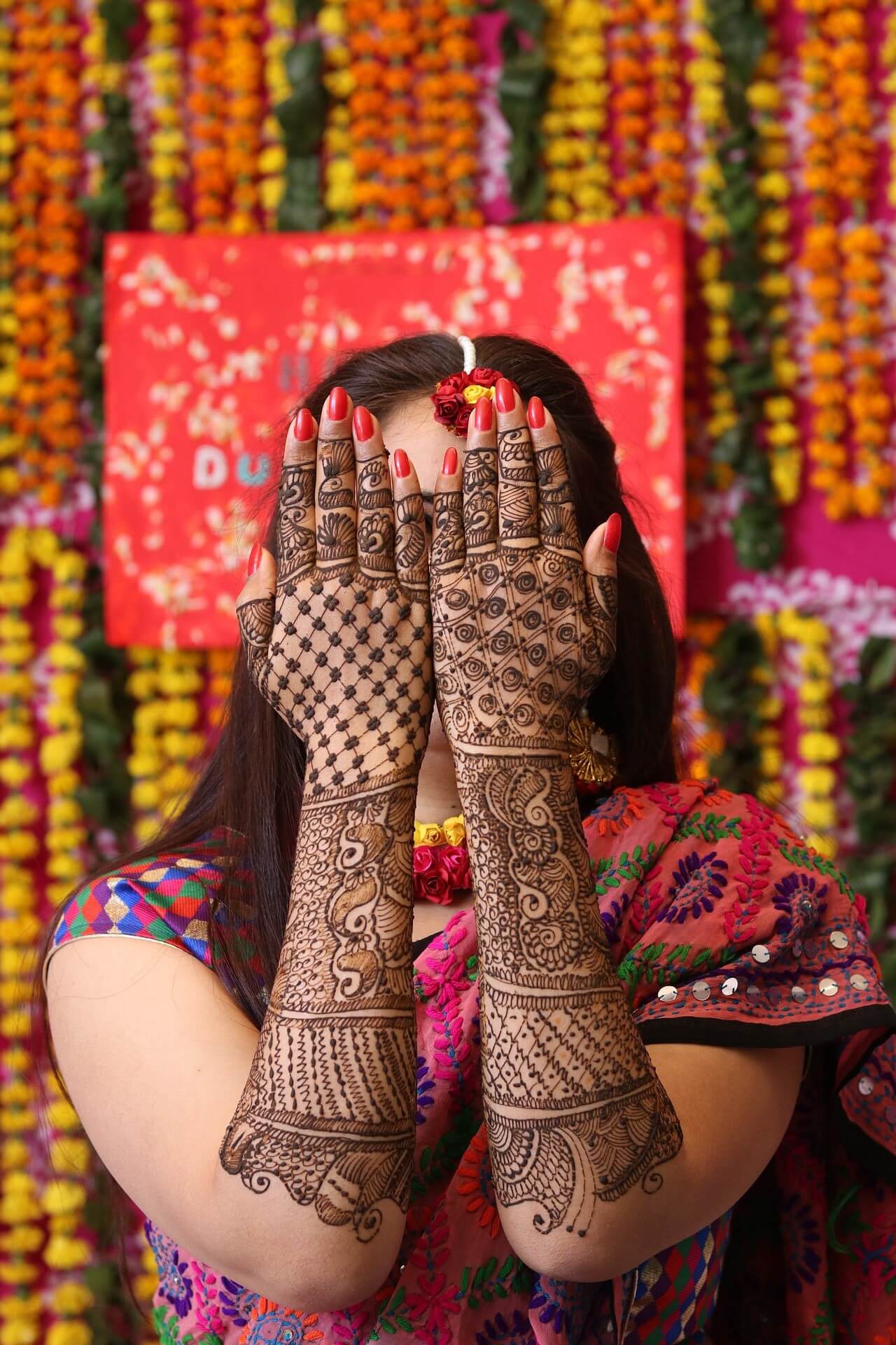 Woman displaying intricate henna designs
