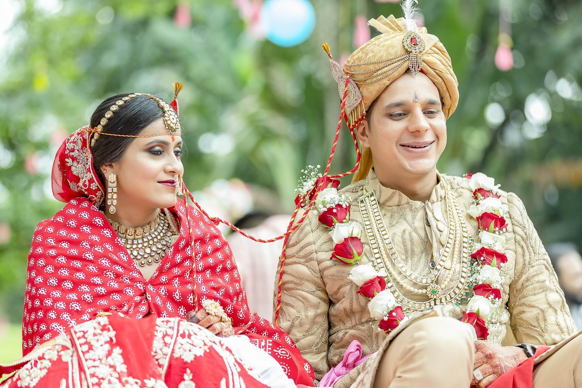 Indian bride and groom smiling in traditional attire